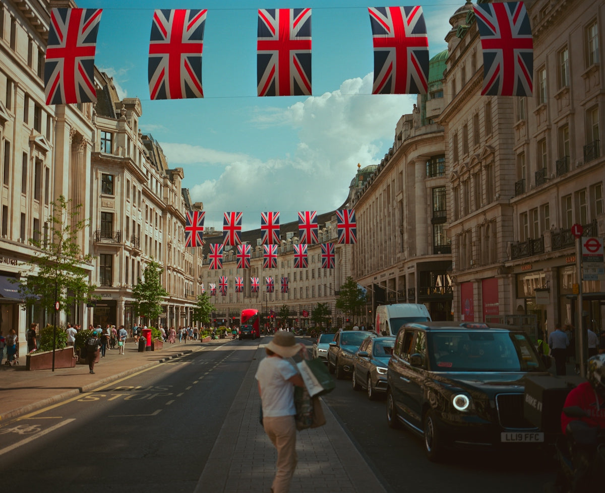 Union jack flags adorn a london street with people